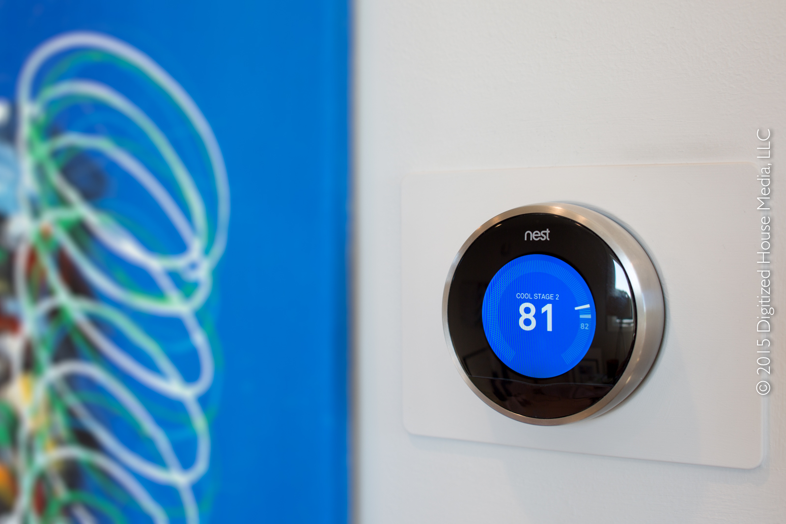 The 2nd-generation Nest smart thermostat on the wall in the upstairs zone.
