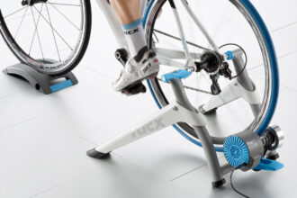 Looking to smarten your workouts? The Tacx Flow Smart Indoor Bike Trainer connects with smartphone apps while it simulates a cycling experience. Image: Tacx.