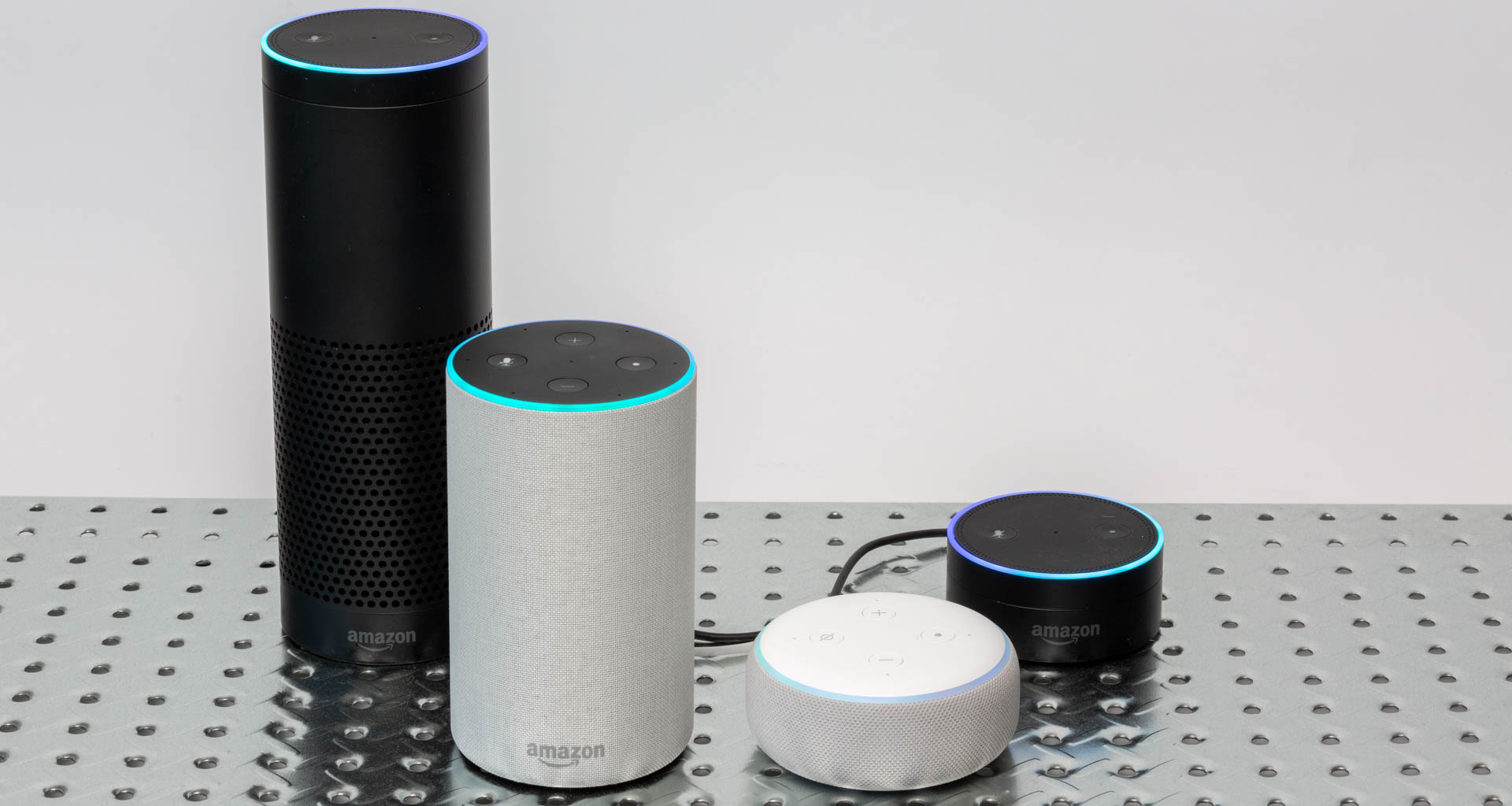 Alexa runs on the entire Amazon Echo speaker line, including these products (left to right): Echo (1st generation), Echo (2nd generation), Echo Dot (3rd generation), and Echo Dot (2nd generation). Image: Digitized House Media.