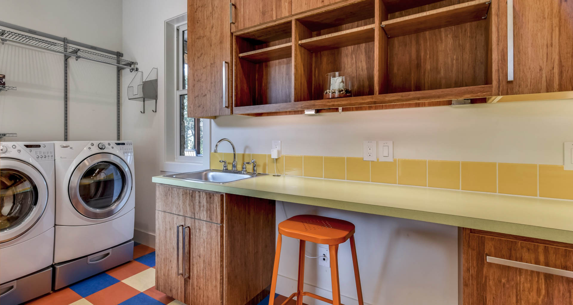 This laundry room easily doubles as a home office space with a built-in desktop and hidden file drawers. Plenty of electrical outlets enable easy recharging for laptops and smartphones. Image: TwistTours.
