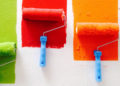 Paint rollers in green red, oranga, blue.