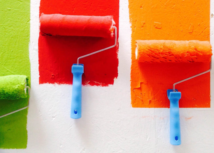 Paint rollers in green red, oranga, blue.