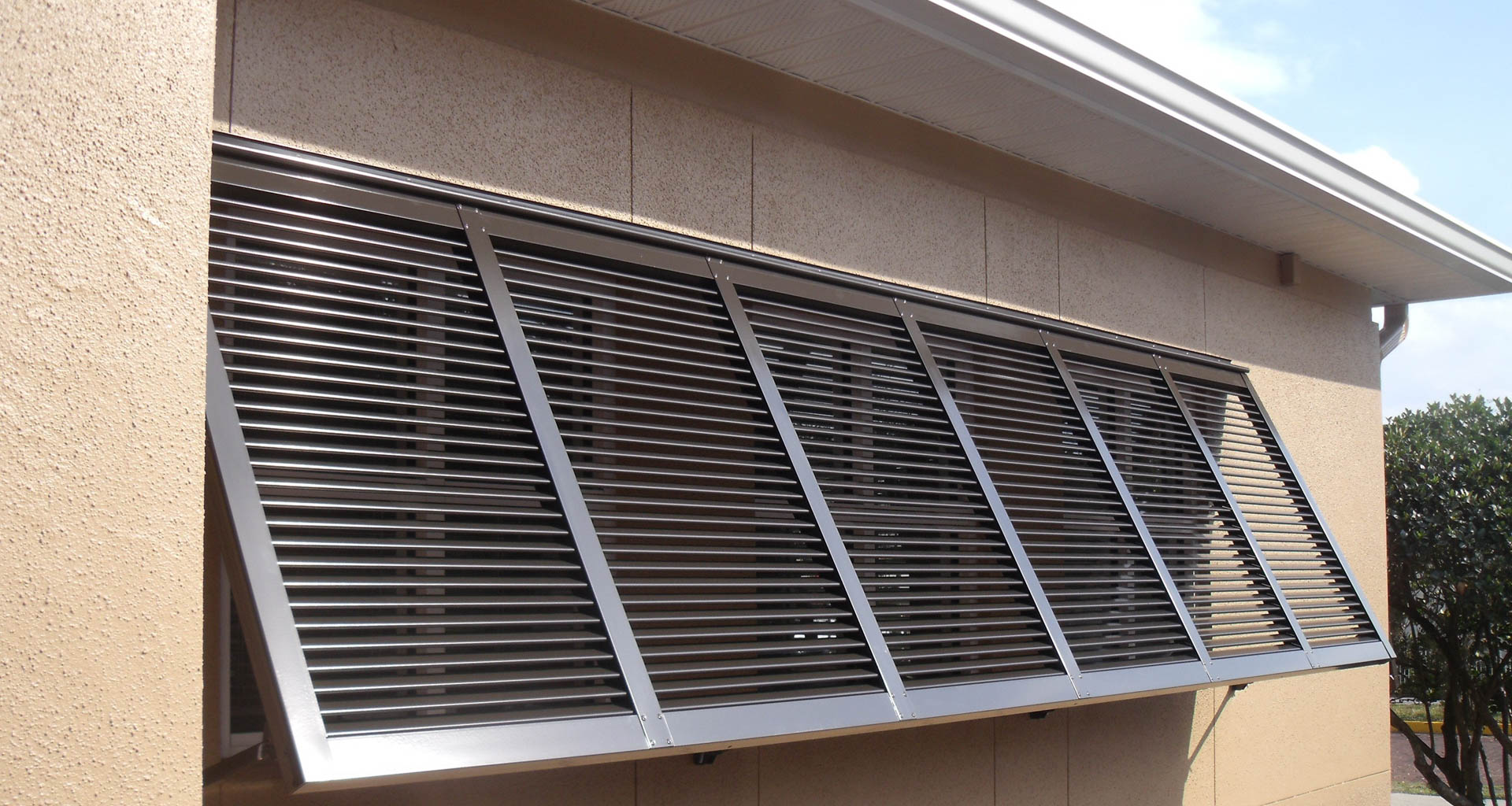 Storm shutters, like the metal Bahama shutters from Sun Barrier Products, can be used to protect vulnerable windows in your home. Image: Sun Barrier Products.