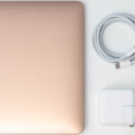 Apple MacBook Air M1 with USB-C power adapter and cable.